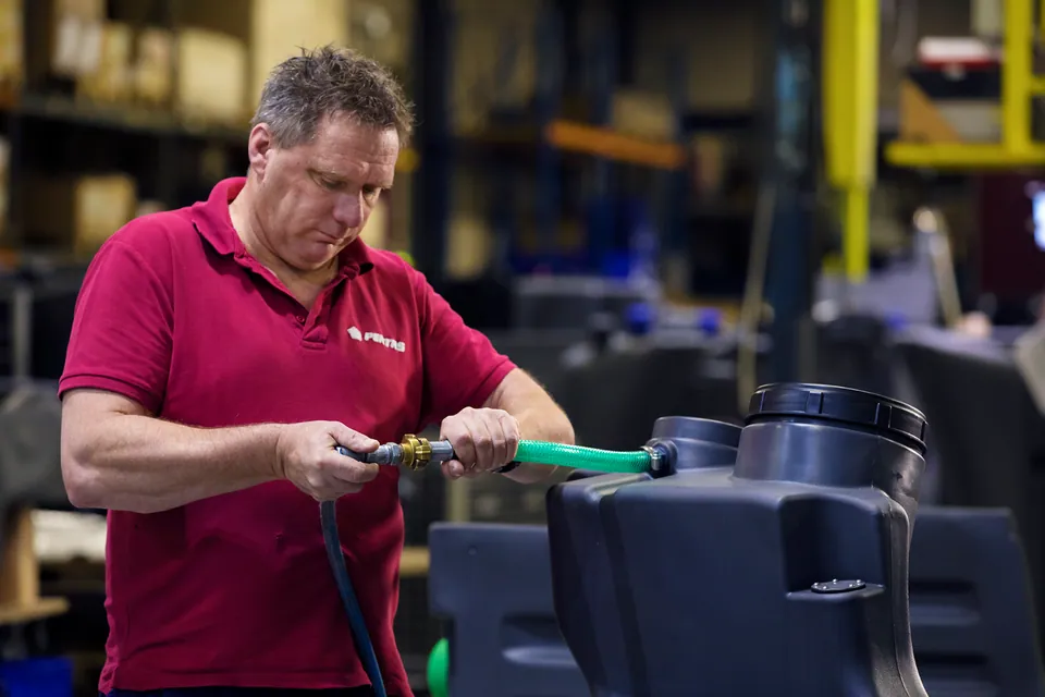 A colleague working on a plastic tank on the Pentas shop floor.